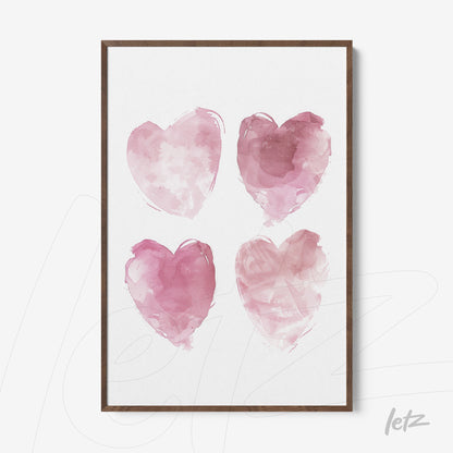 framed art featuring four watercolor hearts in shades of pink with dark wood frame