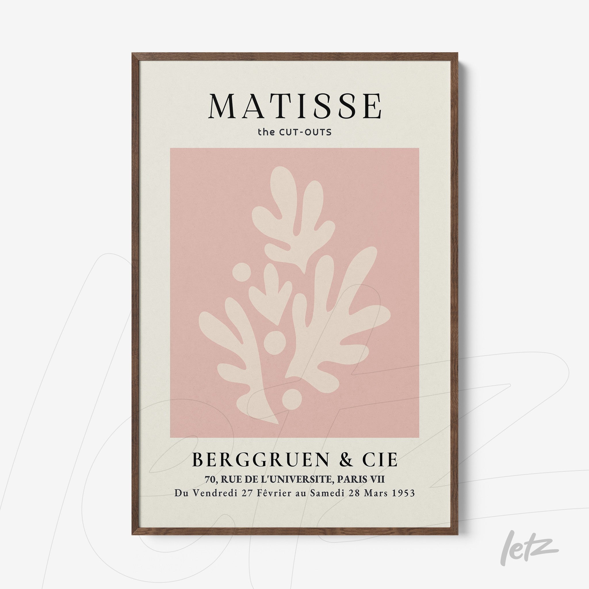 framed modern art featuring abstract shapes in pink against a light background with dark wood frame