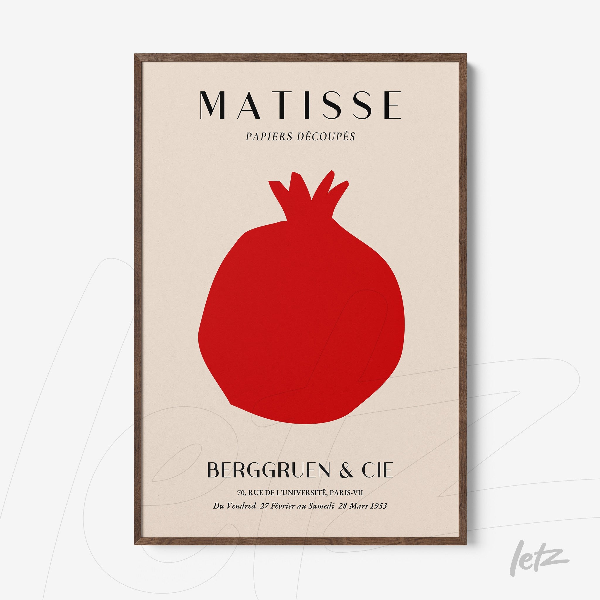 framed wall art in a minimalist style featuring a red pomegranate on a light background, with a dark wood frame