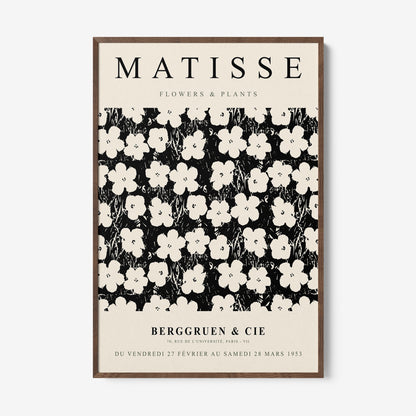 framed artwork inspired by Matisse featuring white flowers on a black background with light wood frame