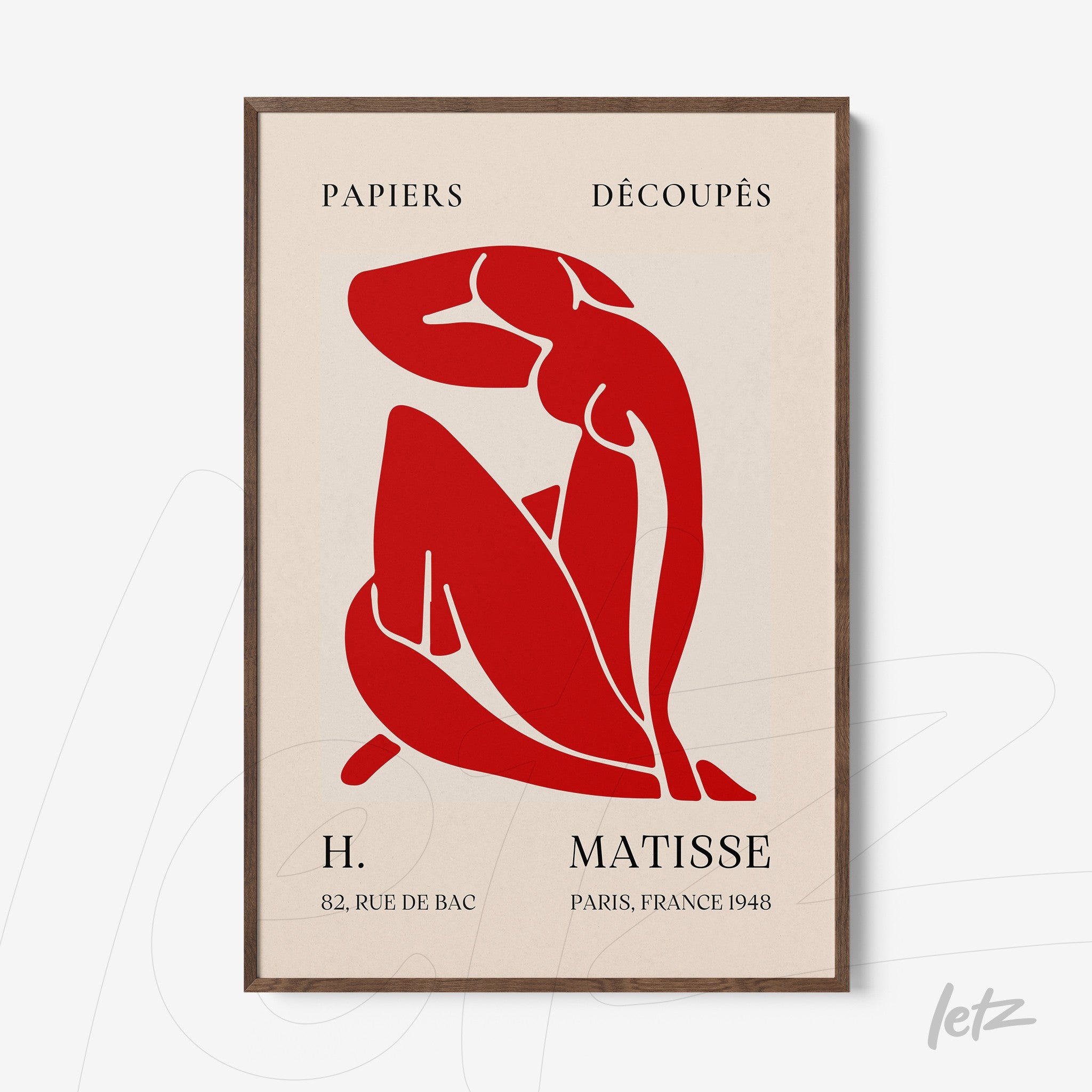 modern art framed print of a female figure in red on a light background with dark wooden frame