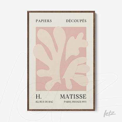 framed wall art featuring abstract leaf shapes in shades of pink and cream with dark wood frame