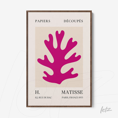 decorative wall art featuring a pink coral cutout on a neutral background with dark wooden frame