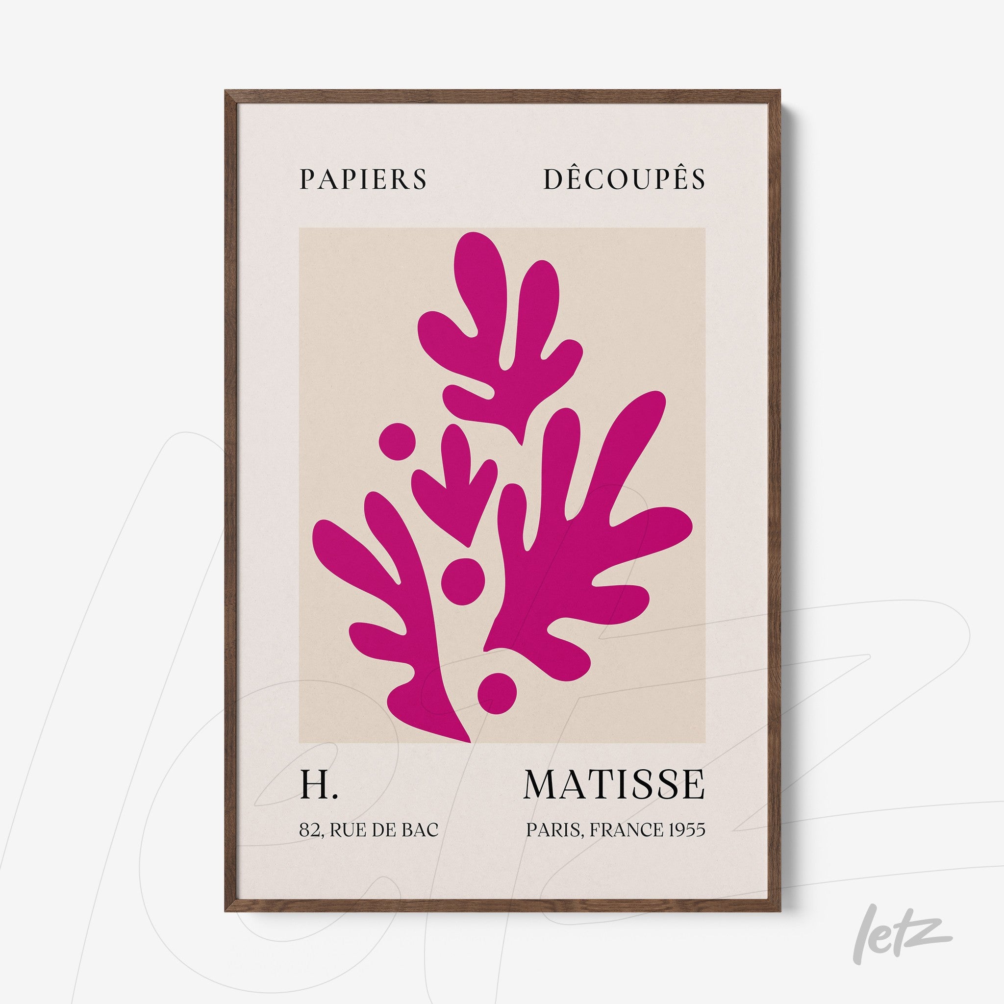 framed modern art print of pink leaves on light background with dark wood frame