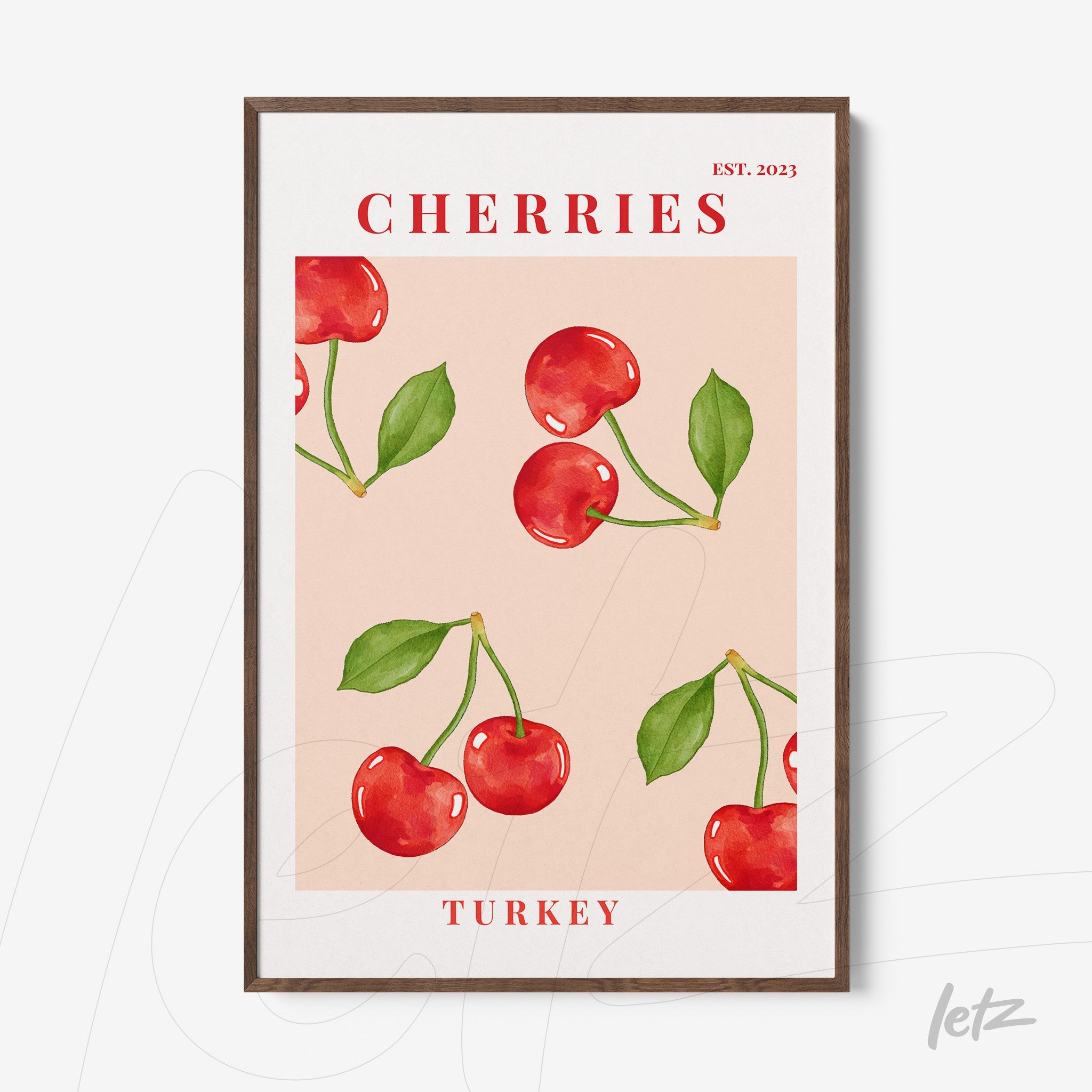 framed wall art featuring red cherries on a light pink background with dark wood frame