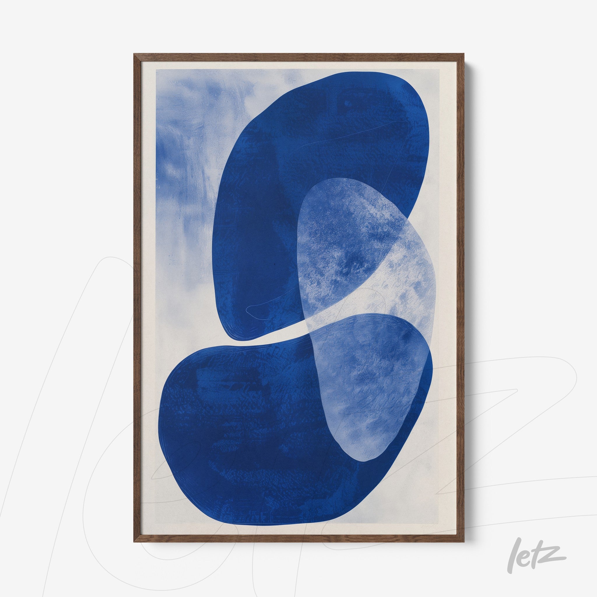 framed wall art with modern abstract shapes in blue and white on a light background