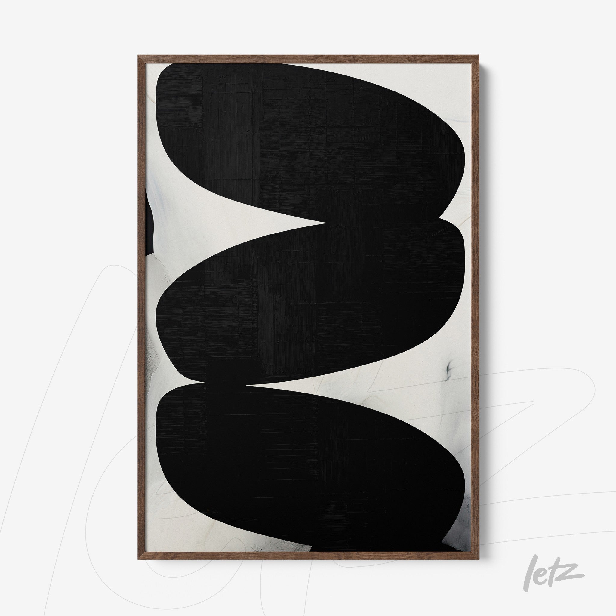 abstract wall art featuring bold black oval shapes on a light background with a dark wood frame