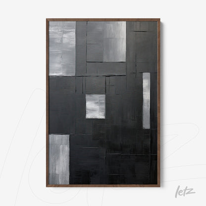 textured abstract wall art in black, gray, and silver tones with dark wood frame