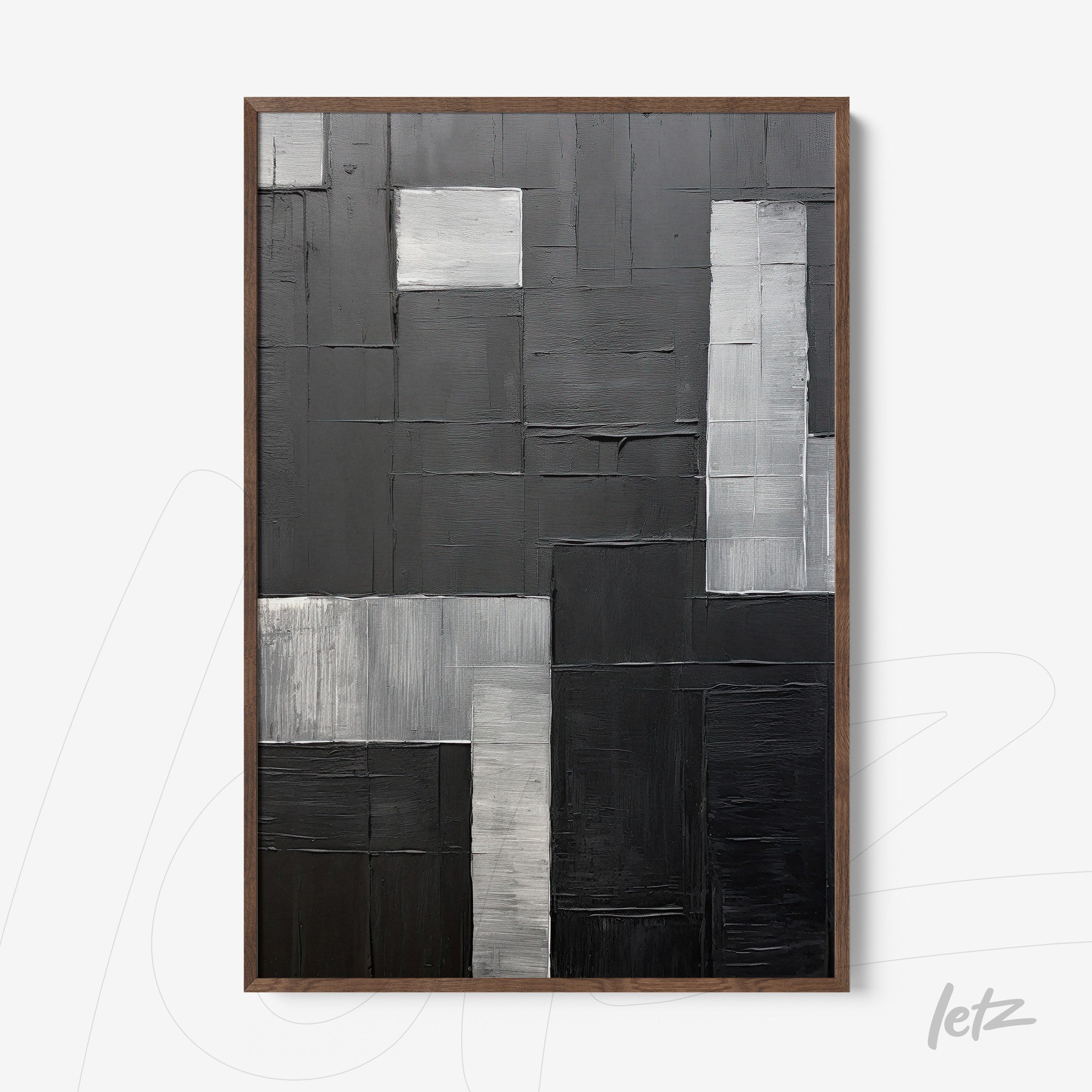 abstract wall art in shades of black and gray with varied textures in light wooden frame
