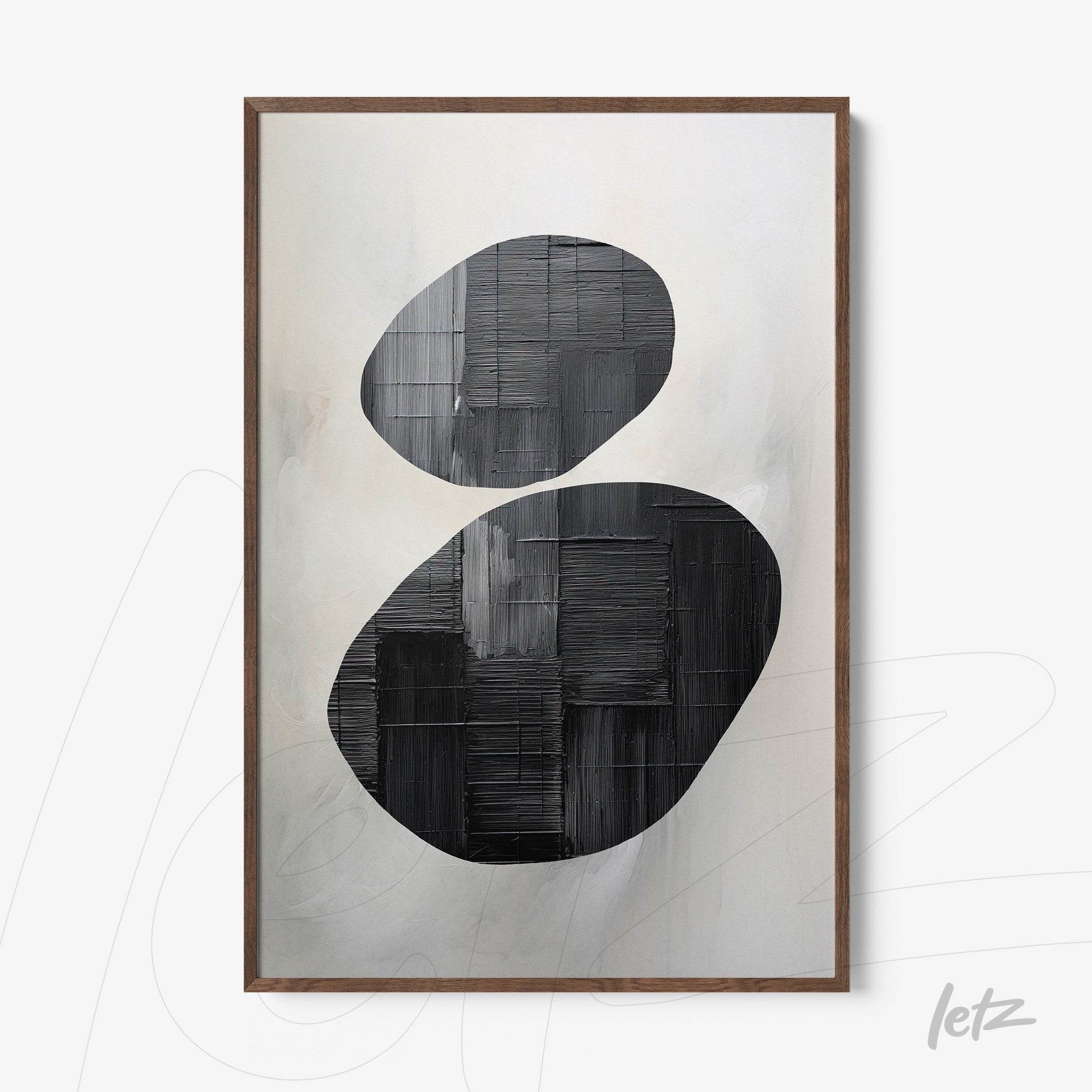 abstract wall art featuring bold black and white oval shapes with light wood frame