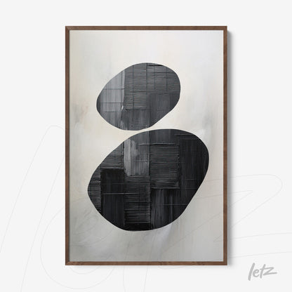 abstract wall art featuring bold black and white oval shapes with light wood frame