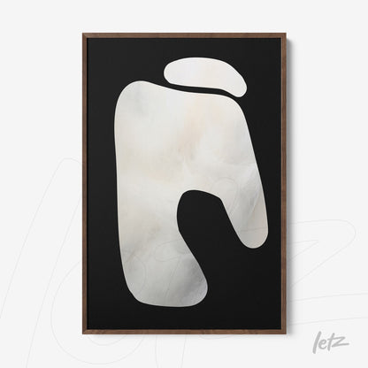 abstract wall art featuring a light organic shape on a black background in a dark wood frame