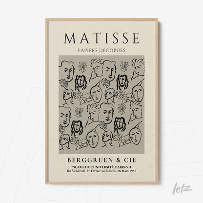 wall art featuring modern style illustration of faces and leaves on gray background in light frame