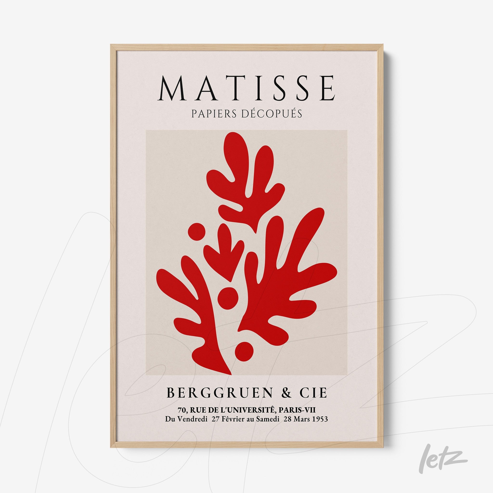 framed modern art print in shades of red depicting organic shapes on a neutral background with light wood frame