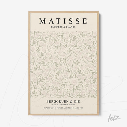 framed wall art featuring a floral and plant illustration on a light background with bold text and light wood frame