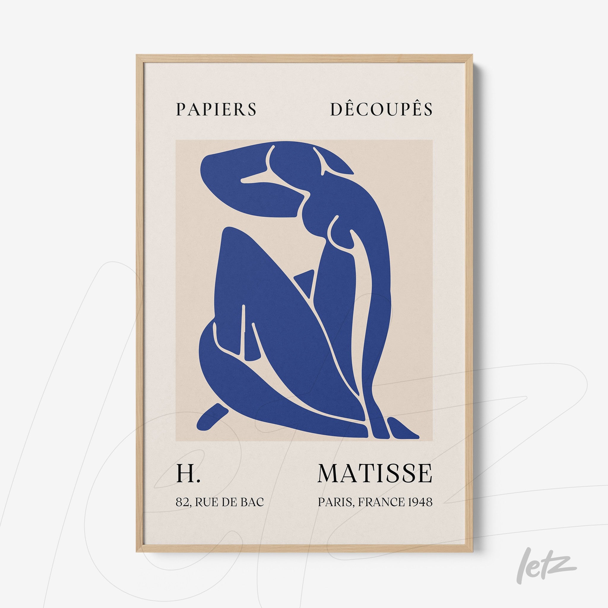 framed artwork featuring a stylized blue silhouette of a nude female figure with a light wood frame