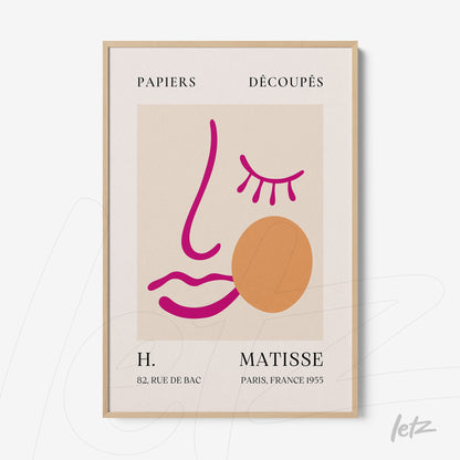 framed minimalistic artwork featuring a stylized face with pink lines and an orange circle on a beige background