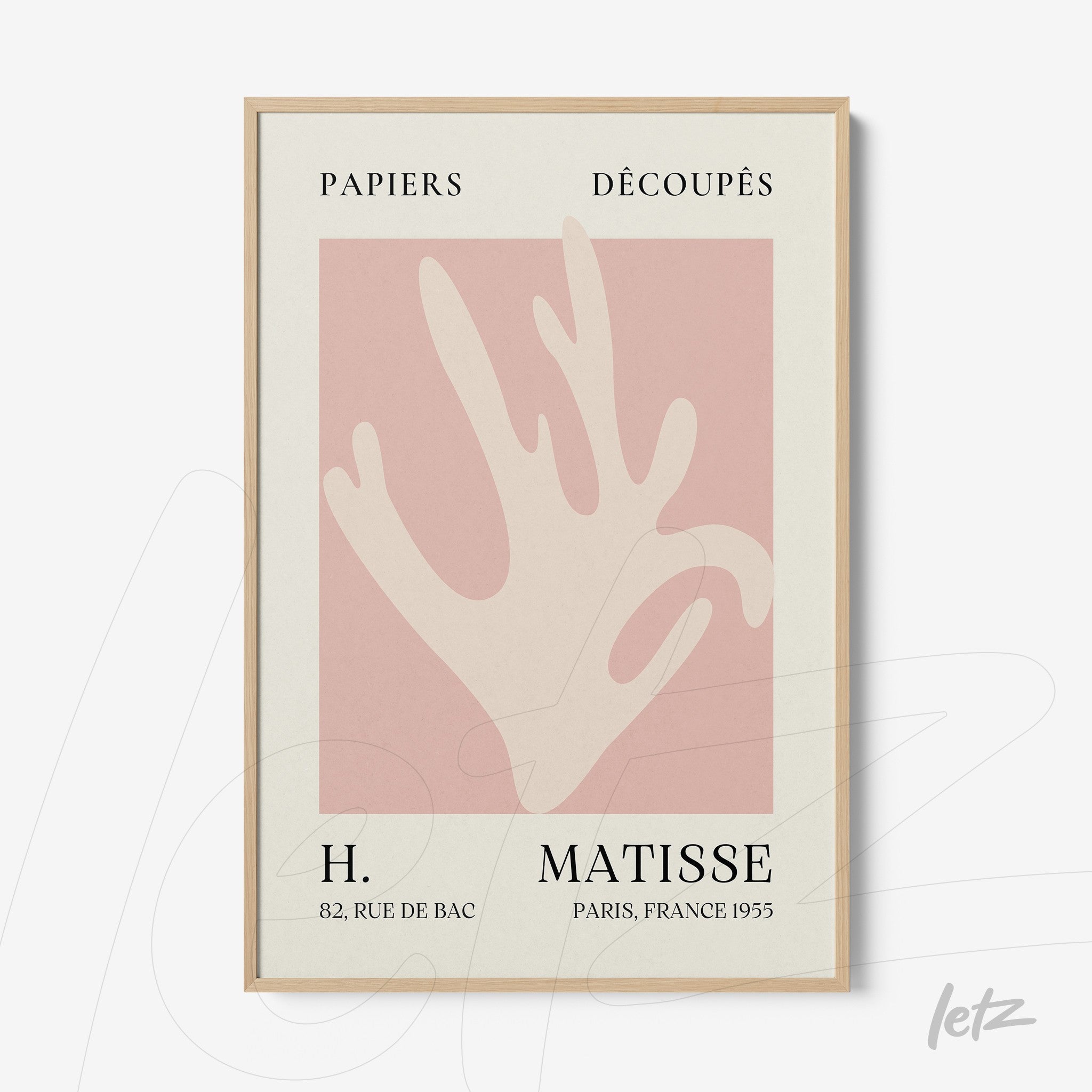 framed wall art featuring a modern hand silhouette against a pink background with light wood frame