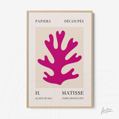 decorative art print featuring colorful cutouts in pink against a light background, framed in light wood