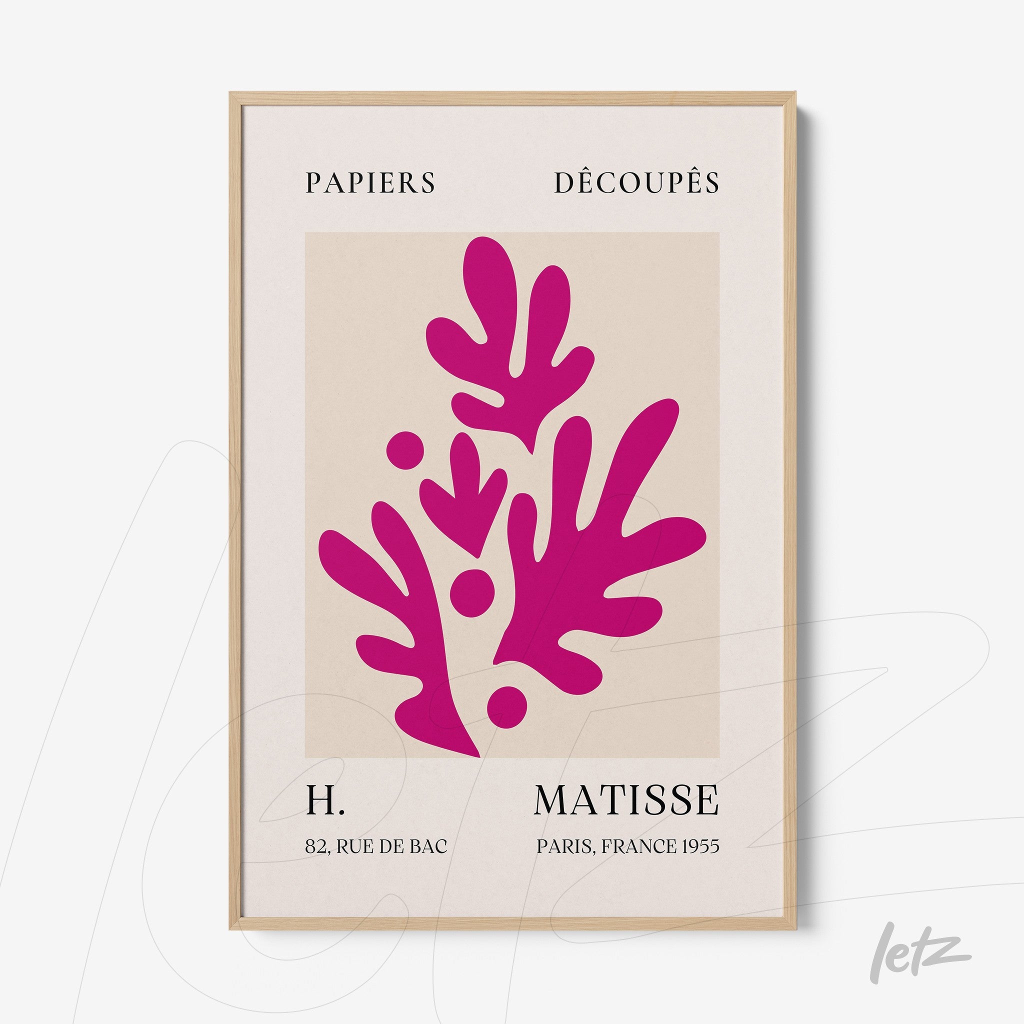 framed wall art featuring cut paper design in vibrant red with light wood frame