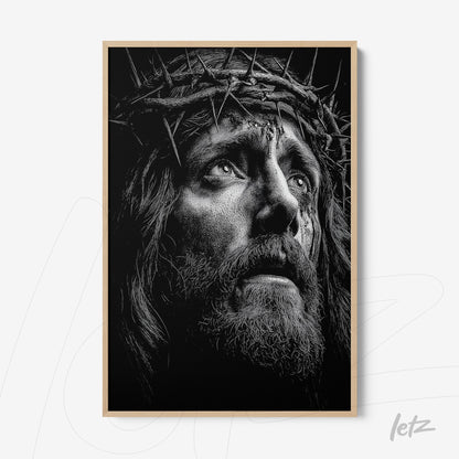 black and white framed art depicting a Christ figure with a crown of thorns and a pained expression in light frame