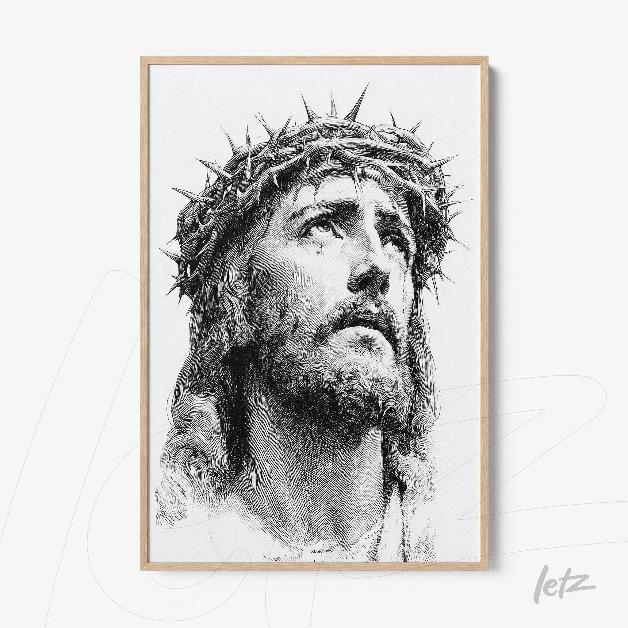 framed artwork with light wood trim featuring a black and white portrait of Jesus wearing a crown of thorns