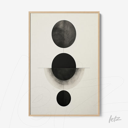 abstract wall art featuring black and white circular shapes on light background in light wood frame