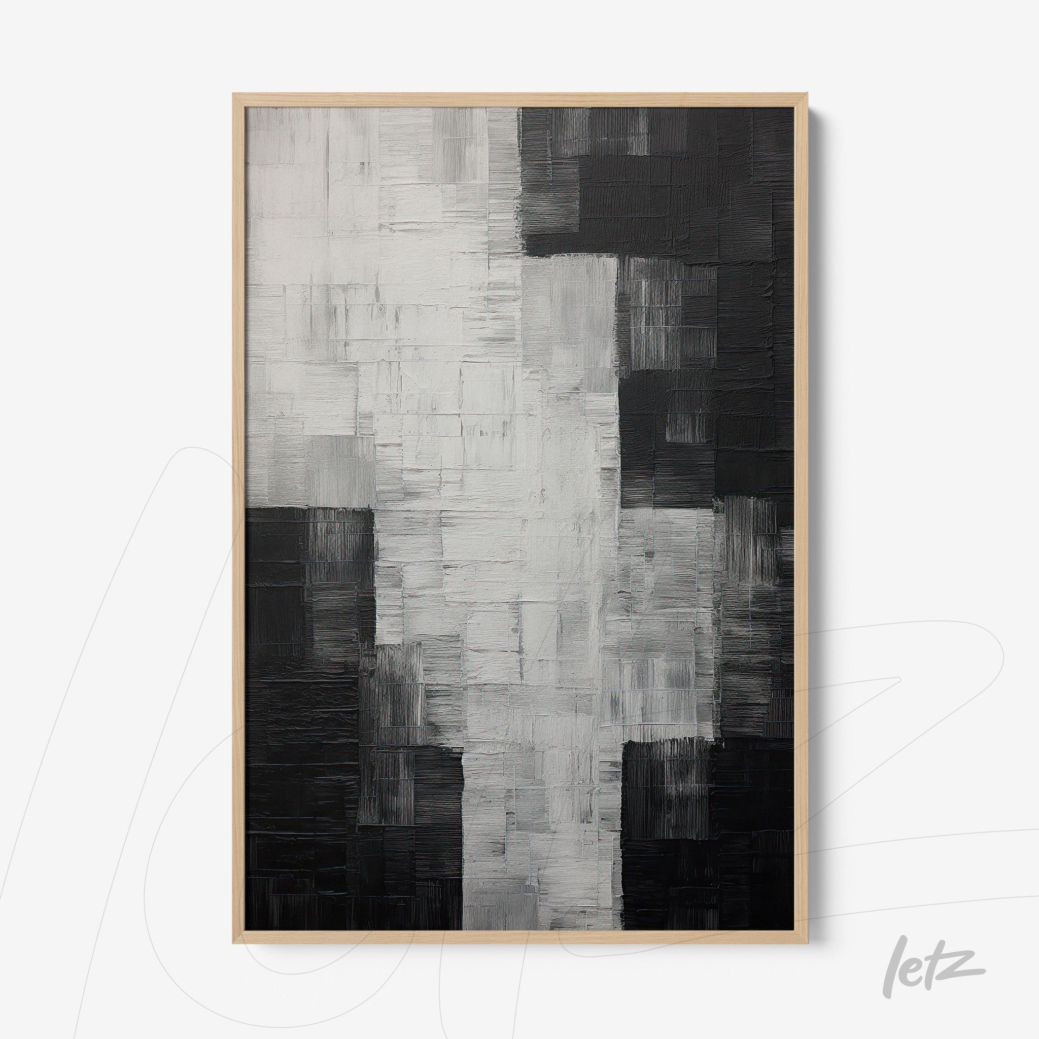 abstract wall art in black and white with textured surfaces in light wood frame