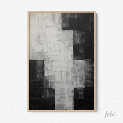 abstract wall art in black and white with textured surfaces in light wood frame
