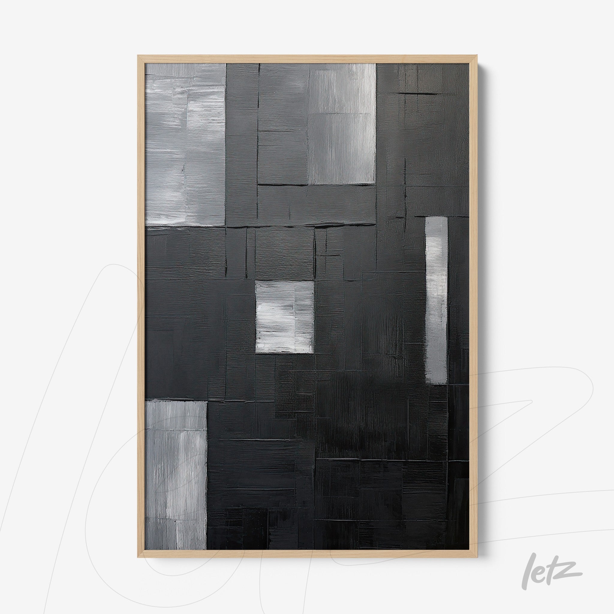 abstract wall art in black and white with varied textures in light frame