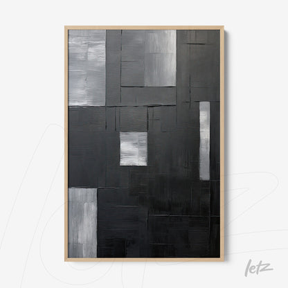 abstract wall art in black and white with varied textures in light frame
