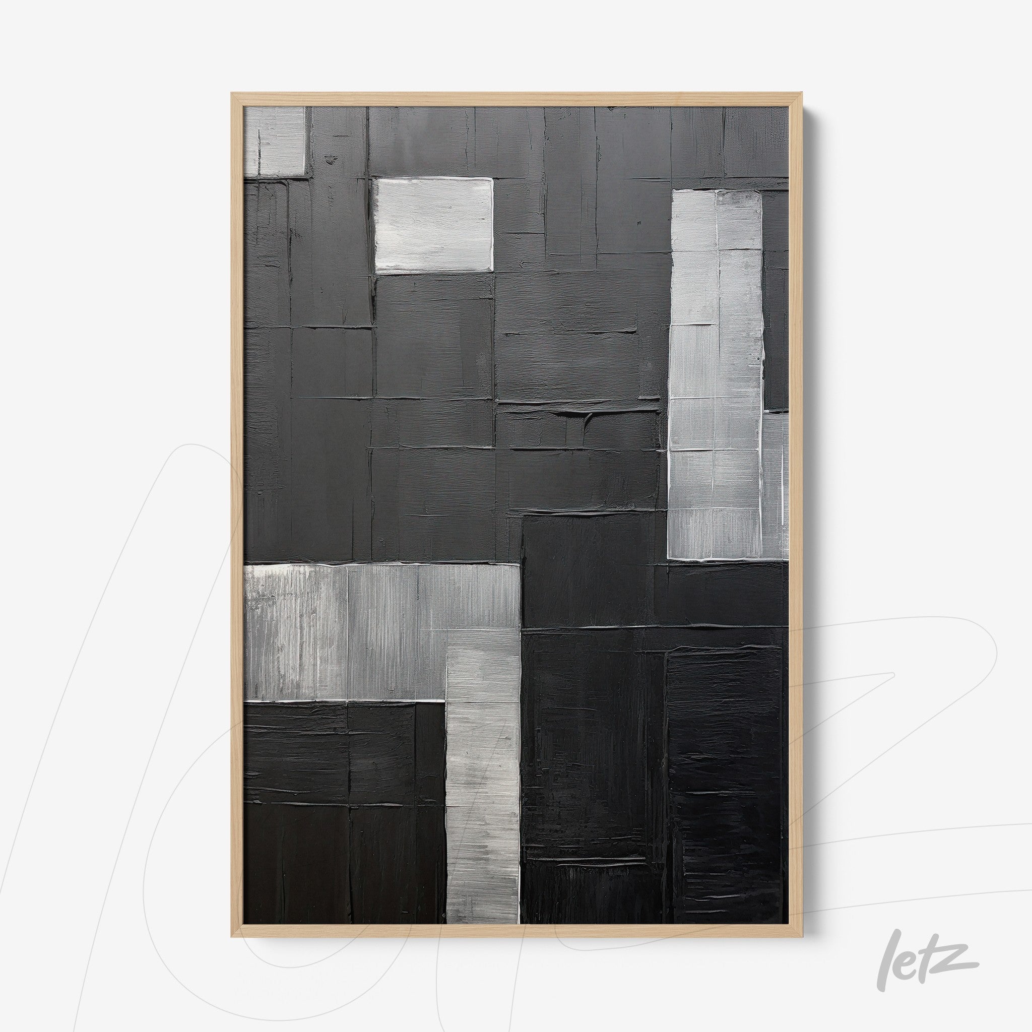 abstract wall art featuring a geometric composition in black, gray, and white, framed in light wood