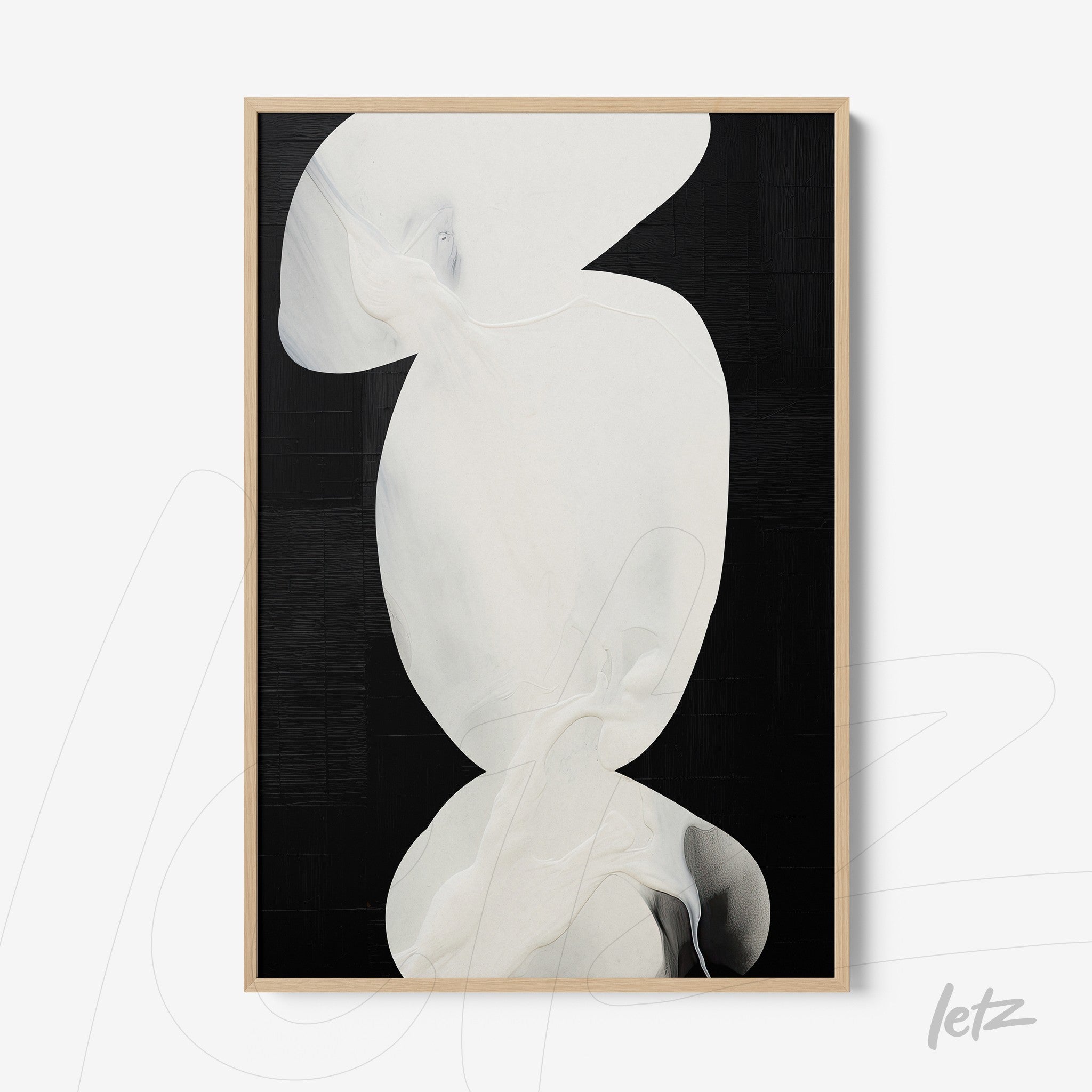 framed abstract art piece with overlapping white shapes on black background and light wood frame