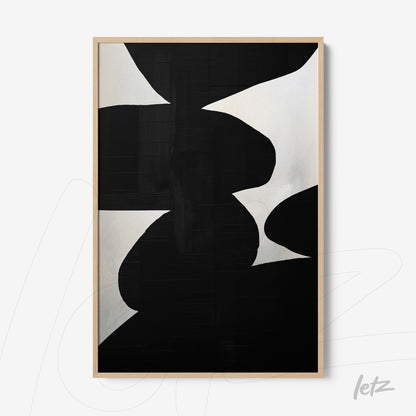 abstract wall art in black and white displayed in a light wood frame