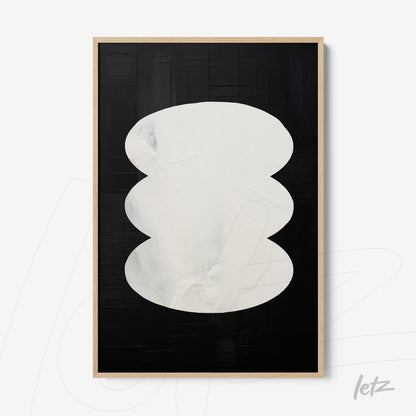 abstract wall art featuring white oval shapes on a black background with light frame
