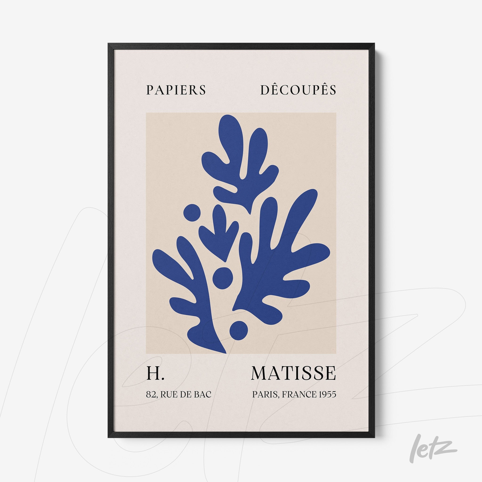 framed art with abstract blue leaves on light background with black frame