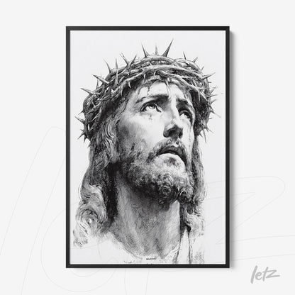 framed black and white wall art depicting a religious figure with a crown of thorns, conveying deep emotional intensity