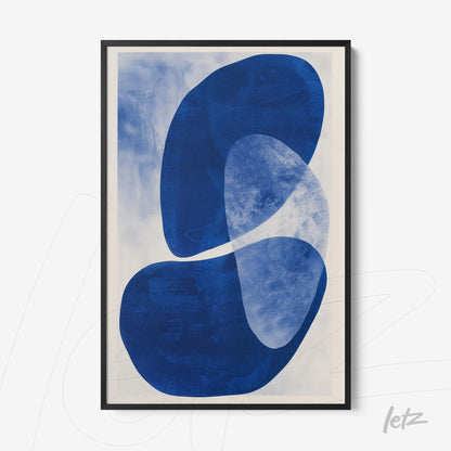 framed wall art featuring abstract blue shapes on a light background with black frame