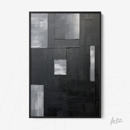 abstract wall art in black and gray featuring multiple textures in black frame