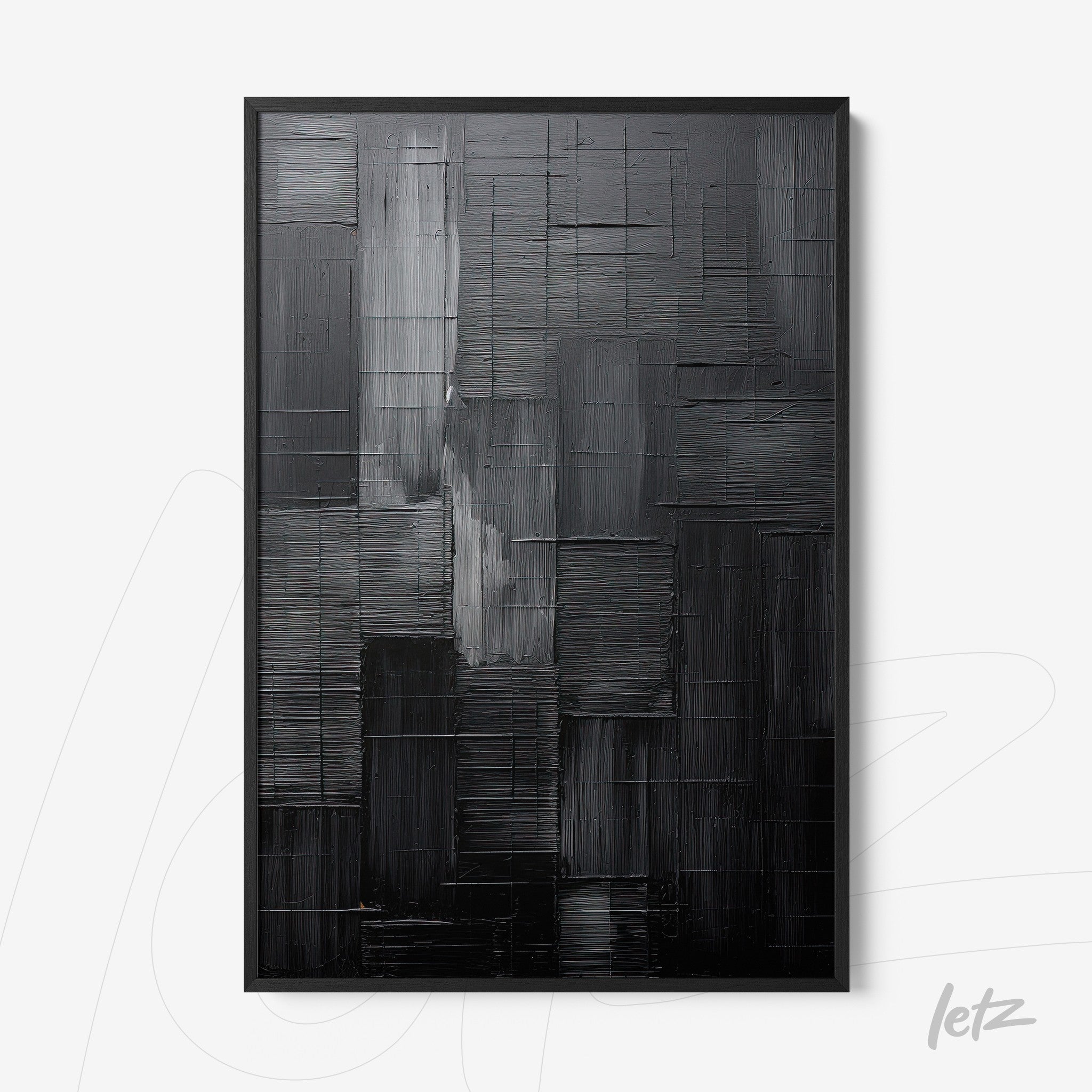 abstract wall art in black and gray tones with marked texture framed in black frame