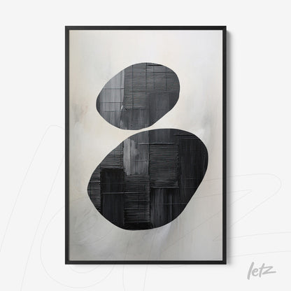 abstract wall art featuring two oval black shapes against a light textured background
