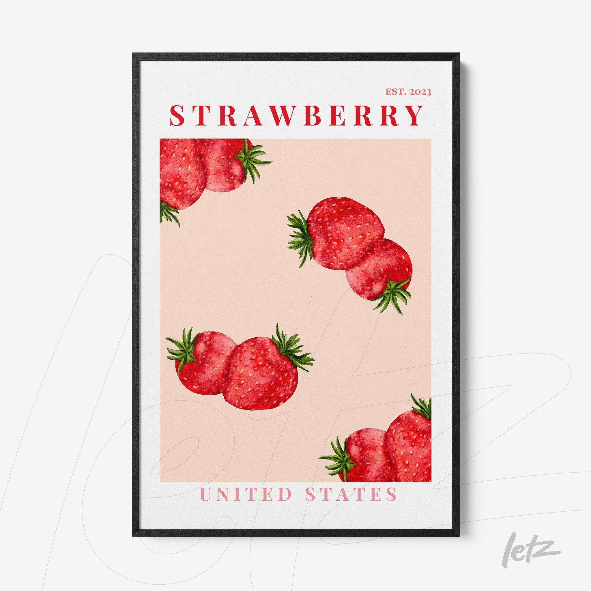 framed wall art featuring strawberries on a pink background with black frame