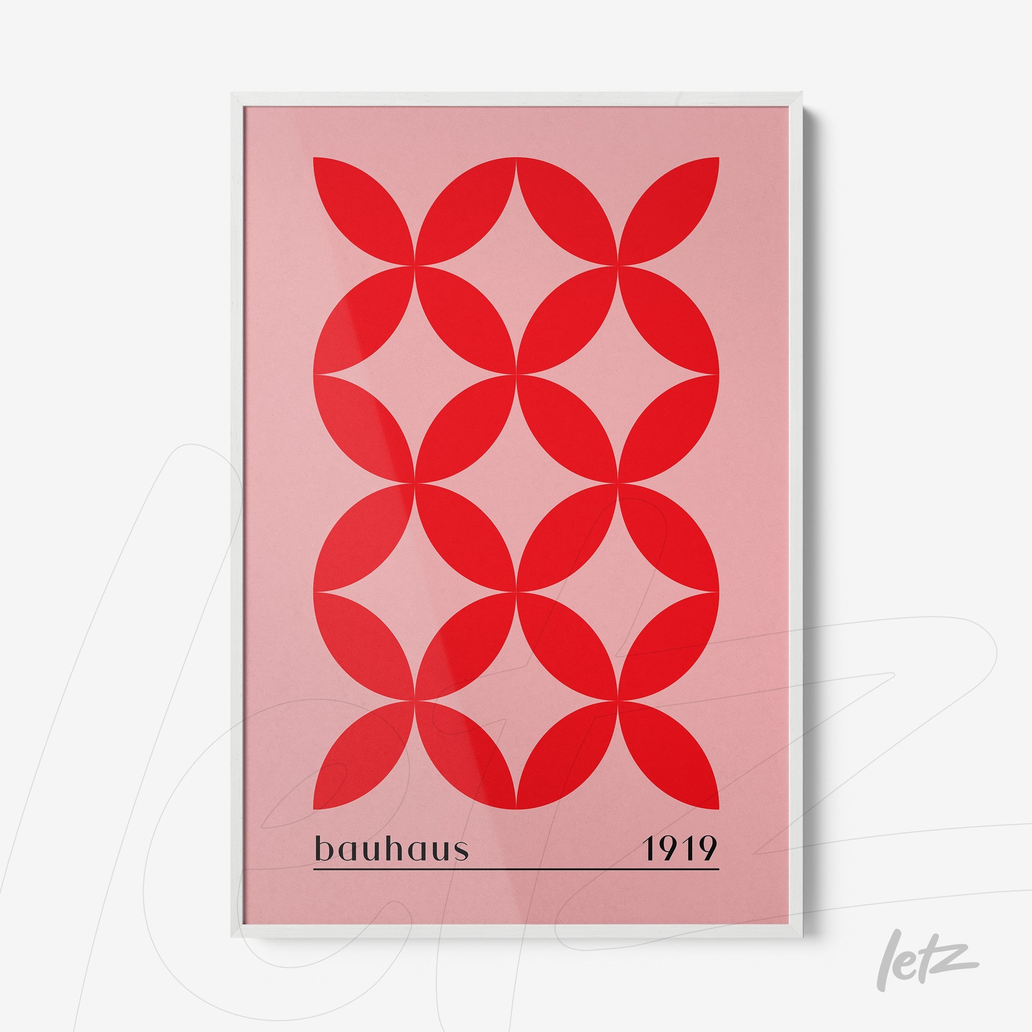 poster print with red geometric shapes on a pink background and white frame