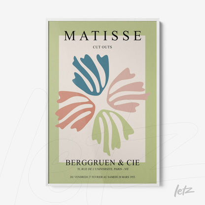 framed artwork in modern style featuring colorful cut-out leaves on light green background with white frame