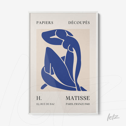 framed artwork of cut paper in blue depicting a seated female figure with a fine white frame and a beige background