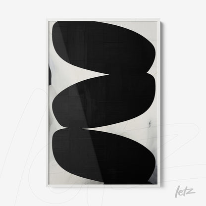 abstract wall art in black and white featuring bold shapes, displayed in a white frame
