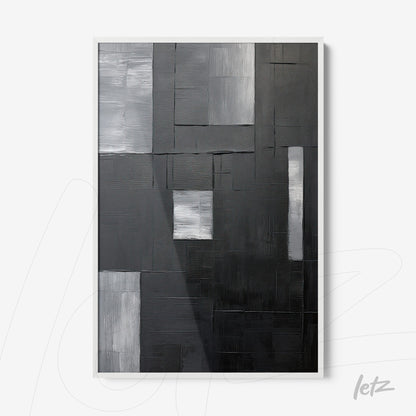 abstract wall art in black and gray tones with a white frame