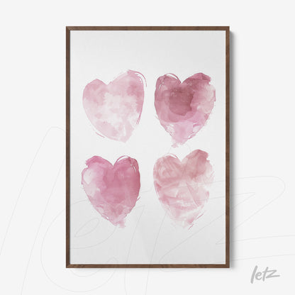 framed artwork featuring four watercolor hearts in shades of pink with a dark wooden frame
