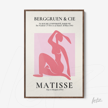 decorative framed modern art piece in pink depicting a female figure in a sensual pose with a dark wooden frame
