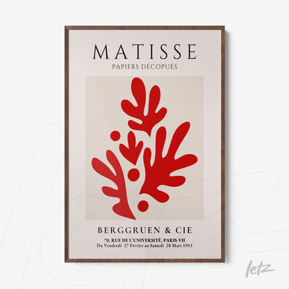 framed wall art featuring modern style red shapes on a light background with a dark wooden frame